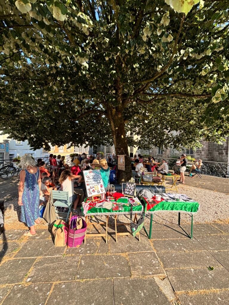 A solidarity stall at a gathering in Brittany, supported by volunteers and local partners