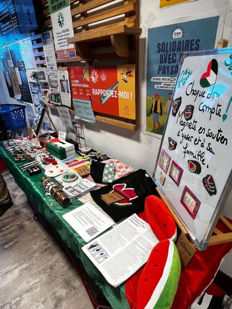 A solidarity stall hosted by a business in Brittany, with volunteer-made items and a donation box